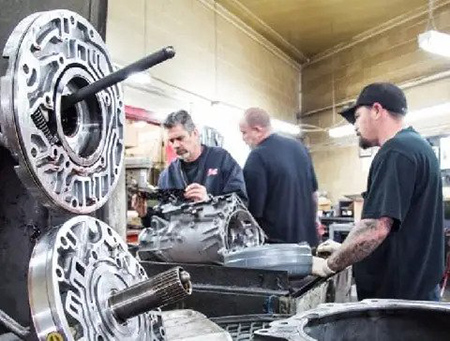 Photo of men fixing engine